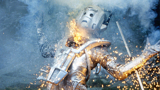 A Cyberman explodes in sparks and falls to the ground