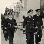 GERMAN OFFICERS BEING LED ON BOARD DIDO TO SIGN THE FINAL SURRENDER OF SHIPPING IN THE BALTIC AREA.
