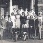 The photograph was taken on December 27, 1942 and shows Jessie Hall (Nee Pridmore) at the far back in the centre of the three girls stood between the two columns