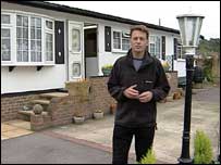Chris Packham outside a mobile home