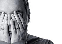 A man covering his eyes