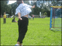 Kid hitting a tennis ball