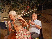 The orchestra in rehearsals on the factory floor