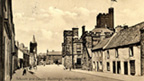 Black and white view along High Street, Kirkcudbright, showing the Tolbooth and the County Building.