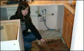 Katherine pulls a grumpy face after finding rotten flors hidden beneth the carpet.