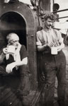 Two trawlermen in front of the galley of an Aberdeen trawler