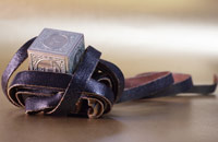 A tefillin, a cube made of metal with a leather strap. © Ethan Myserson/iStockphoto