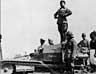 Benito Mussolini giving an address from the top of an armoured vehicle c.1940