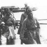 Japanese soldiers boarding HMS Sussex in 1945