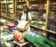 A woman working in a sari shop