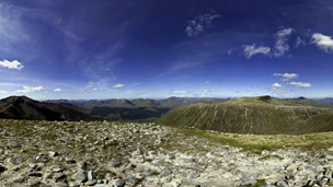 View from the rocky top of Beinn nan Aighenan on a partly-cloudy day.