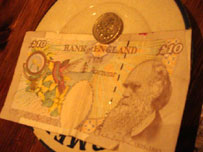 Note and coin on a plate (photo: Jack Gore)