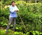 Alan Titchmarsh standing in the garden