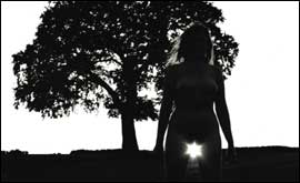 A woman with a tree in the background