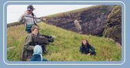 Julie clings to the cliff edge.