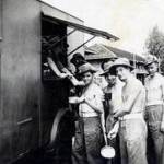 Jack Strong (centre - wearing glasses,) with his mates from the 1st. Battalion, Queen's Royal Regiment - collecting tea from the FANY lorry at Bang Kang prison, Bangkok - August 1946.