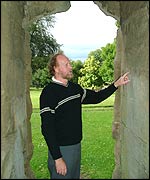 Archaeologist John Hemingway  looking at the mortar joints in the Priory