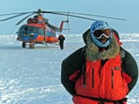 john stands in front of helicopter on artic ice