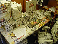 desk covered in newspaper
