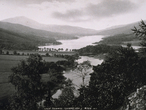 Black and white view of Loch Tummel with hills around and Schiehallion behind.
