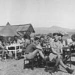 Mr. Harold Dawson, 2nd facing camera at table. 'B' Flight, tented camp at Salerno 1944