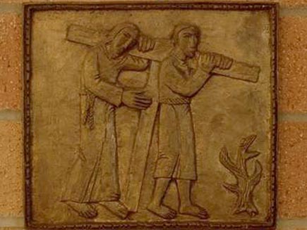 Simon of Cyrene bears the cross for Jesus