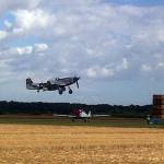 A P51 Mustang landing at Boxted Airfield fly in over half a century after they flew from there during the war.