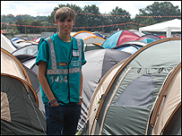 Alex standing by the tents