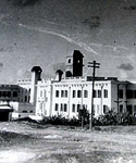 Maltese hospital, with fighter aircraft trails in sky above