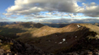 View from the rocky top of Ben Starav on a partly-cloudy day.