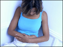 A woman clutching her stomach