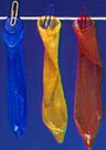 three coloured condoms on a washing line