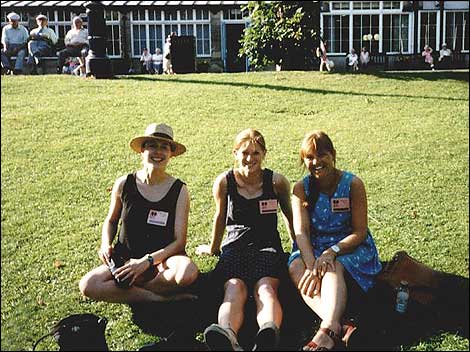 Three women sitting on grass