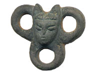 a copper alloy object with a face in the middle
