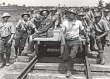 A group of Royal Engineers at work on a light railway line near Boesinghe, grouped around a flat truck, 31 July - 2 August, Battle of Pilckem Ridge  