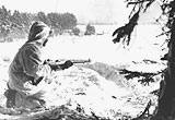 GI standing guard in a snowy field, January 1945