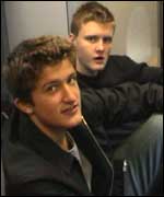 Two boys sitting in the corridor