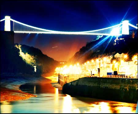 An illuminated bridge over the gorge and river