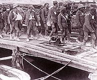 Allied wounded are on their way to the ships that will evacuate them from the Gallipoli peninsula