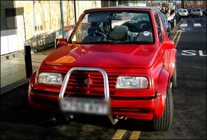 Red 4x4 badly parked