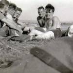A Small group holding the usual discussion on What?..Women and home affairs or the war news. Bet your life.
