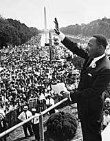 Martin Luther King waves to the crowd of more than 200,000 people gathered on the Mall during the March on Washington, after delivering his 'I Have A Dream' speech