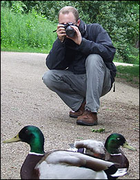 Ben Heather taking a photo of ducks in Christchurch Park