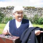Joy with her overcoat, pullover and attache case