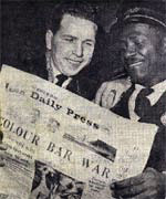 Bus workers reading a newspaper