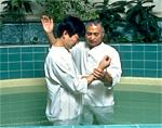 A young Mormon waits in a pool to be baptised