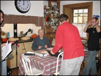People recording a play in a kitchen