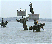 The masts of the SS Montgomery sticking out of the water