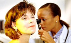 A doctor examines a patients ear