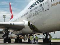 Airport staff inspect damage © AP